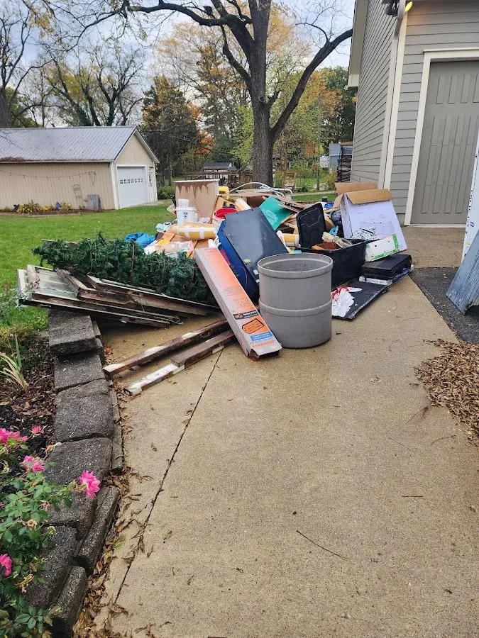 Dumpster being loaded with debris for Estate Cleanout Dumpster Rental in Wamego